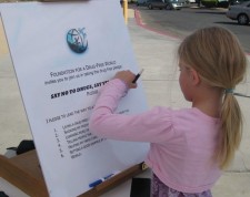 Youngster takes her first step toward a drug-free life by signing the Foundation for a Drug-Free World pledge at a booth at Randsburg, California, Old West Days.