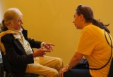 A Scientology Volunteer Minister provides one-on-one help to one of the visitors to the bright yellow pavilion they set up in Fusagasugá, Colombia.