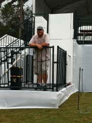 Michael Sok stands proudly in front of one of 101 Mobility's wheelchair lifts for the Web.com Tournament.