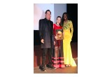 Vida accepts her Excellence in Media award from presenters Ford Austin and Laverne Tillis
