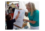 Kern Country Drug-Free World Coordinator Vicki Rizzardini helps children pledge to live drug-free lives at the Randsburg Old West Days.    